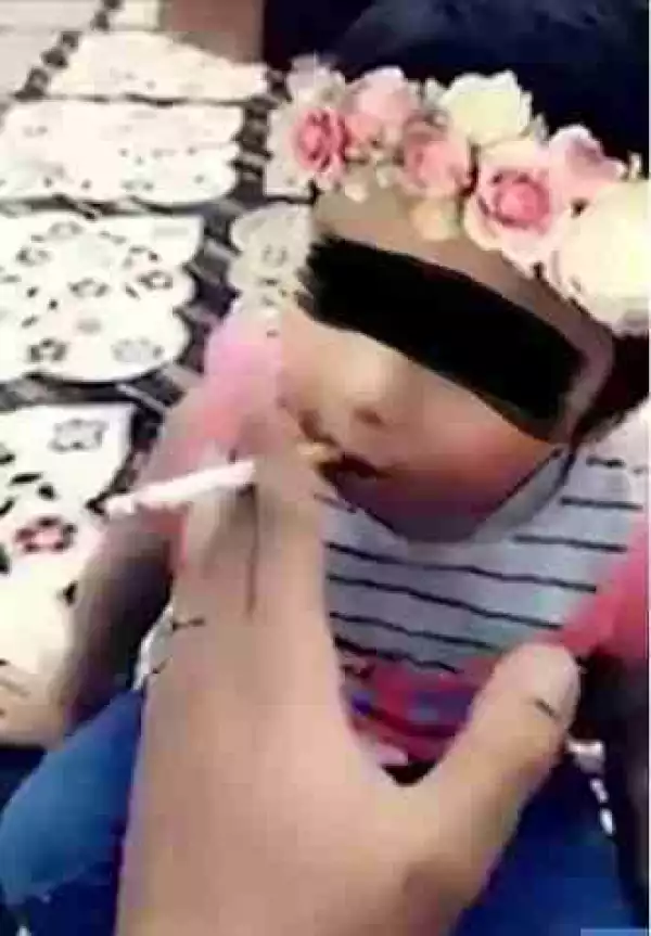 Unbelievable: Man Caught On Camera Teaching His Baby Daughter How To Smoke A Cigarette (Photos)